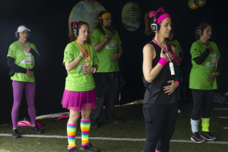 A group in jazzercise clothing take a collective cleansing breath