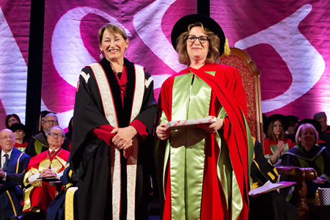 Principal presents award to a faculty member