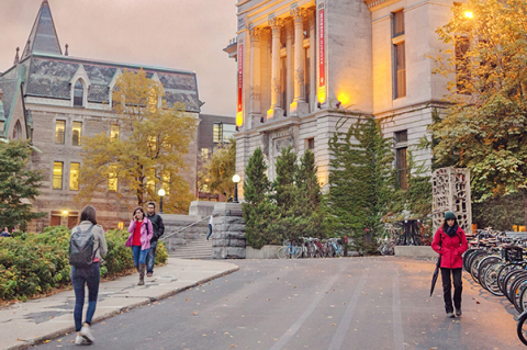 Students walking on McGill campus at dusk