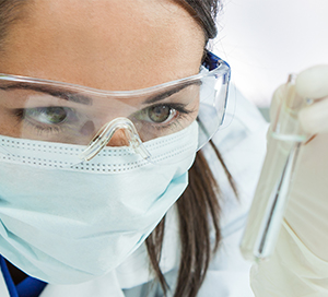 Young graduate student researcher with test tube 