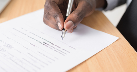 Researcher signing a document