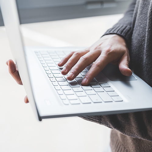 Hands holding a laptop computer