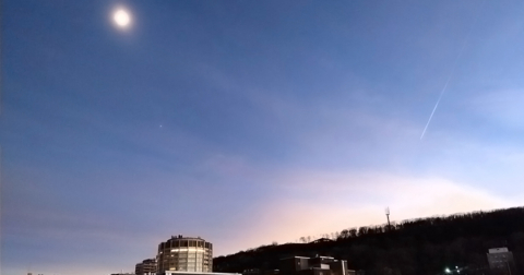 Solar eclipse shown with the McIntyre Medical Building and Mont Royal. 