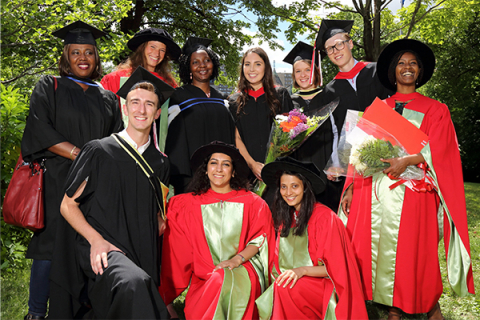 A group of graduates strike a pose at the graduation ceremony.