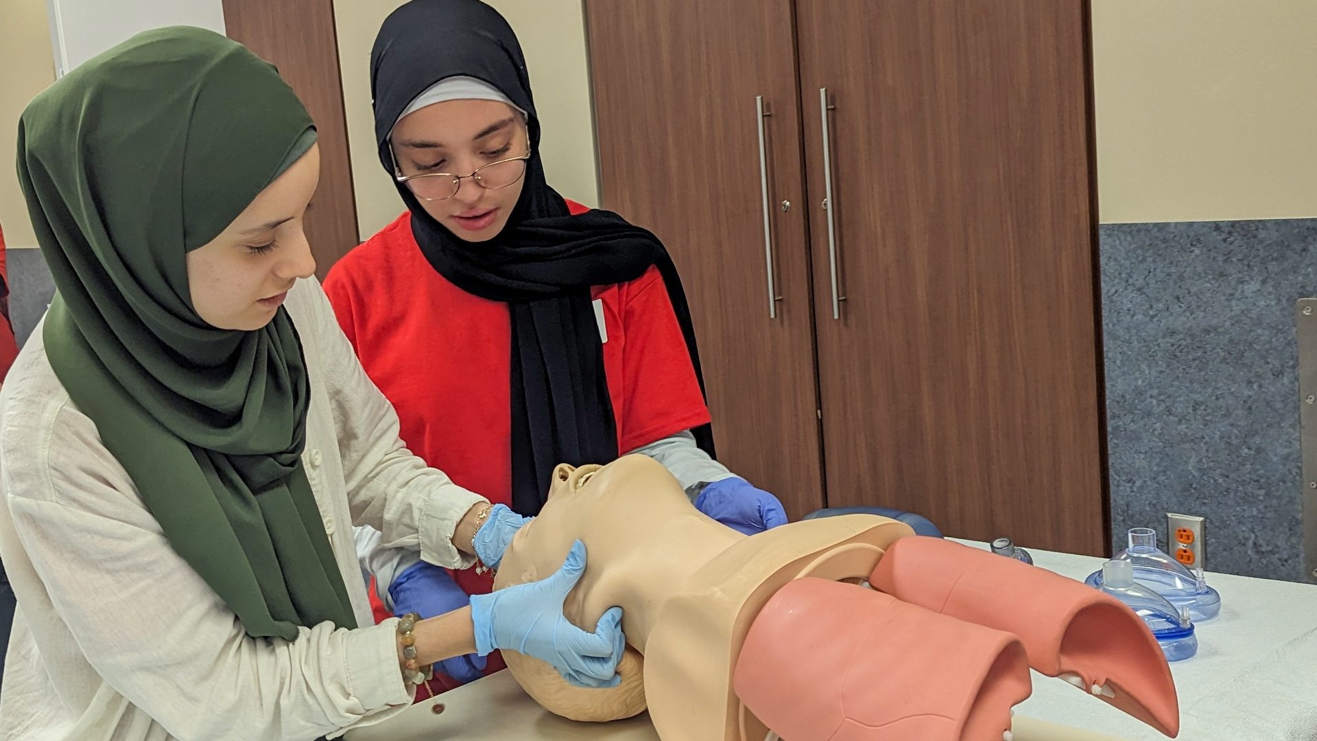 Students checking airways on a manikin