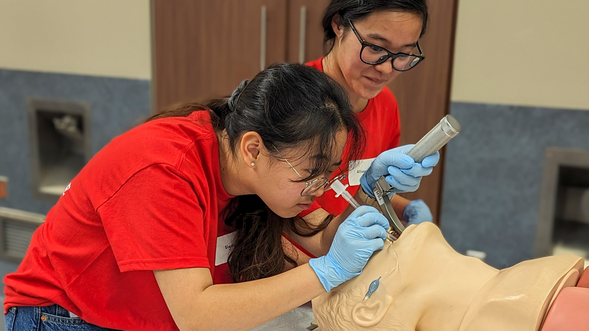 Students intubating a manikin