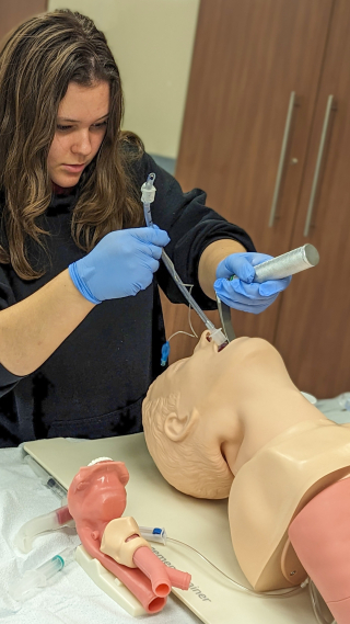 Student intubating a manikin