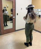 nursing student interacting with VR headset