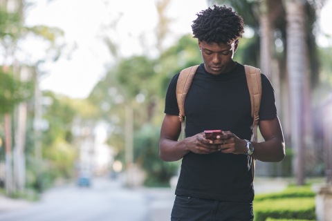 Student typing on cellphone