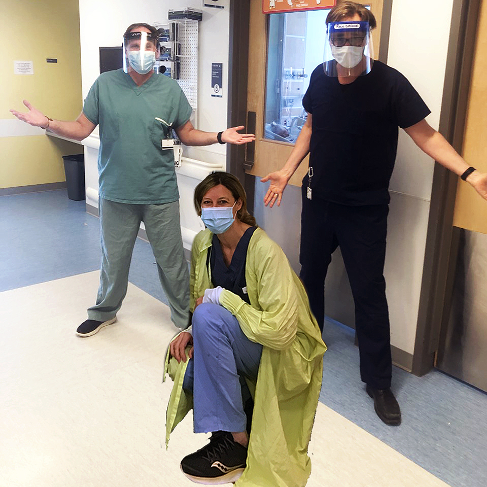 Three medical staff posing for a photo in a lab