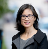 Dao Nguyen dressed in black and grey, smiling