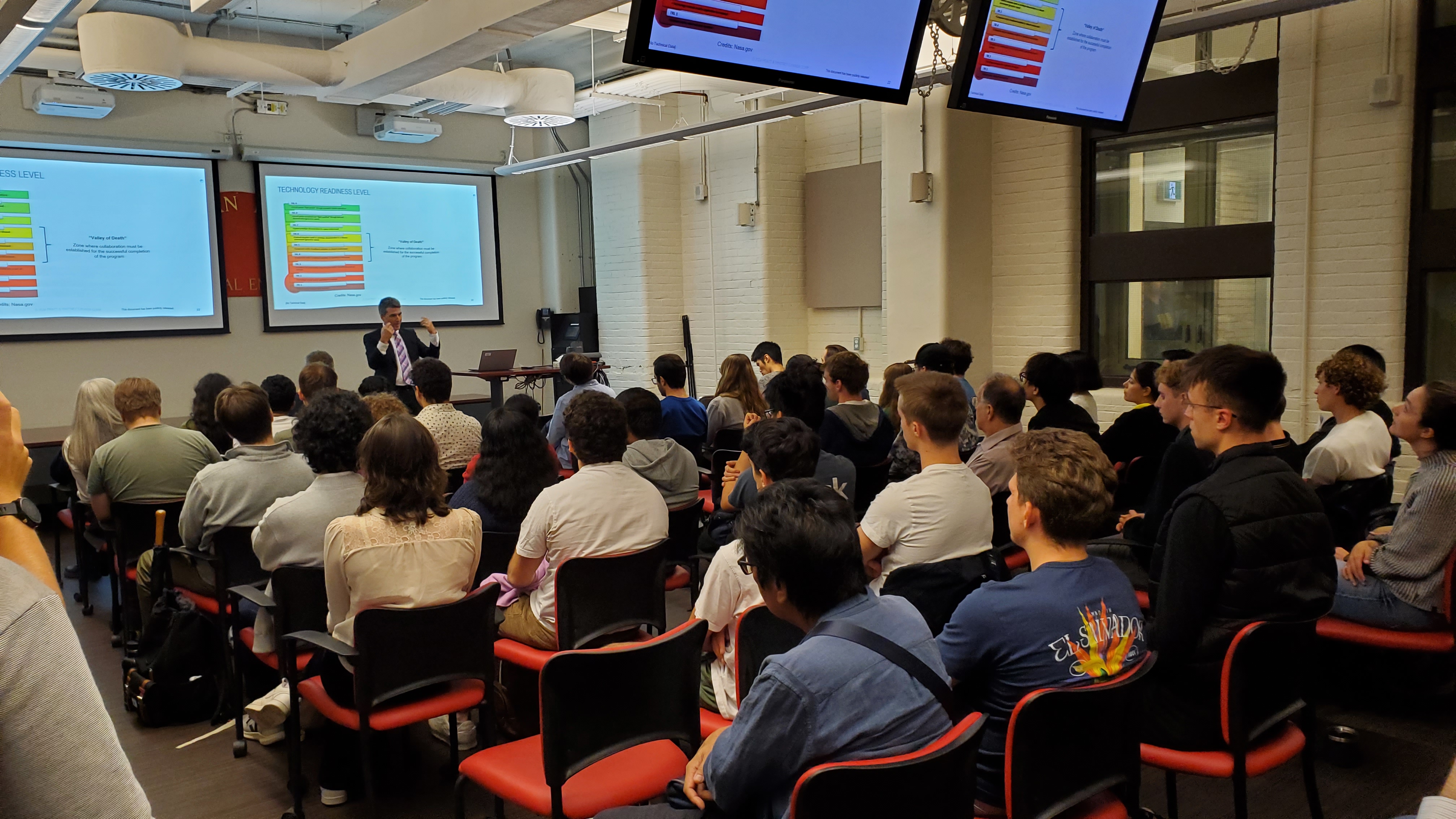 Jean Thommasin speaking to an audience at McGill University.