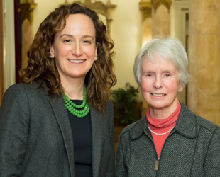 Headshot of two women standing together
