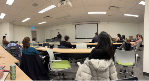 Many people sitting in a classroom.