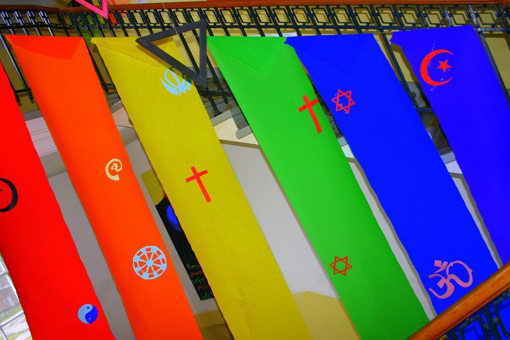 Colourful banner with multifaith symbols on it