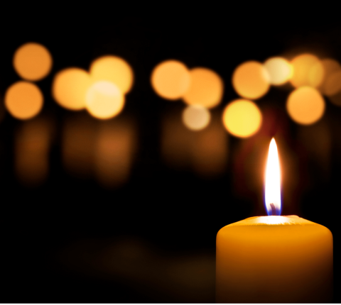 Many lit candles glowing