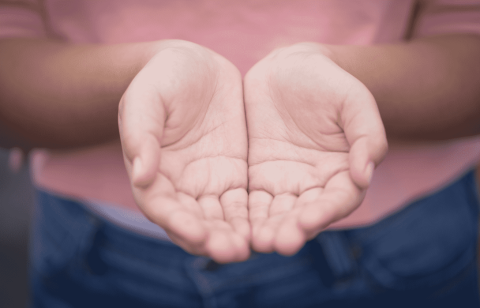 two hands cupped open toward the sky