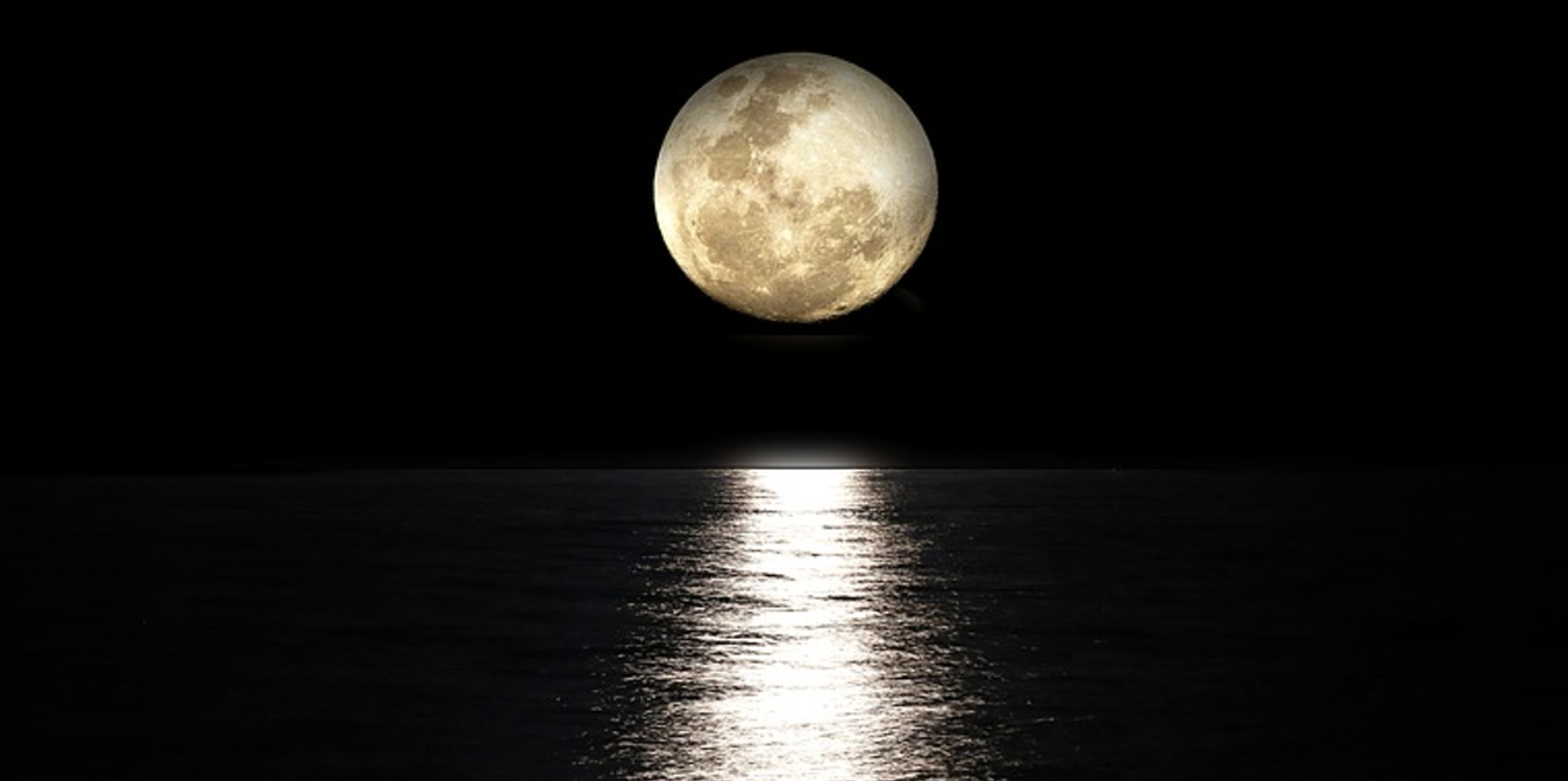 A full moon, reflected on water