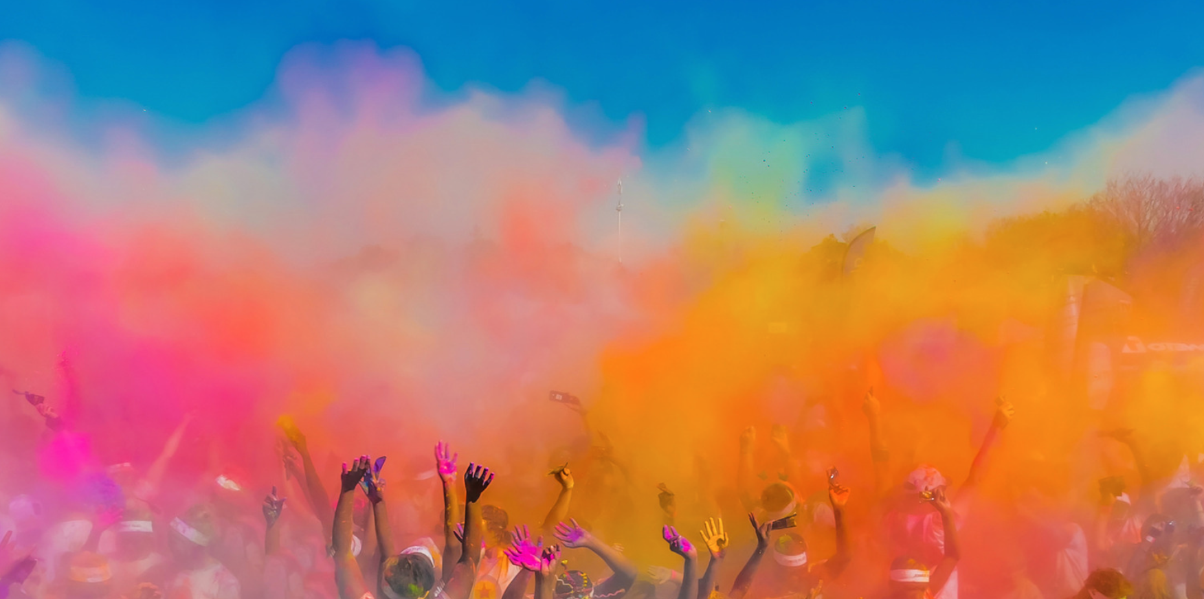 Colourful powders being thrown in the air during a Holi celebration
