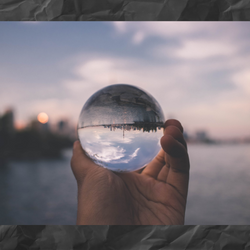 hand holding sphere changing vision upside down