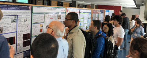 Students and professors looking at research posters