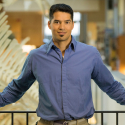 Professor Kai Chan is standing in front of a railing