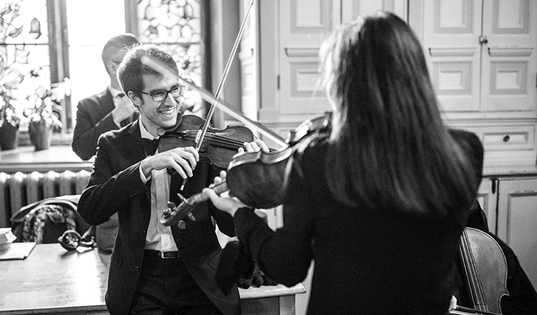 Student musicians playing violins