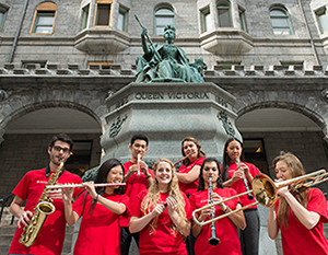 Schulich Shoof of Music students holding instruments standing of front of building