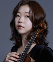 Head portrait of young woman holding violin