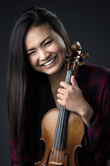 Photo of Kiarra Saito-Beckman holding a violin