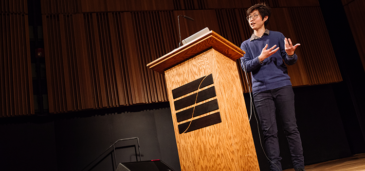 Lena Heng standing at lectern during a 2018-19 Research Alive Series event