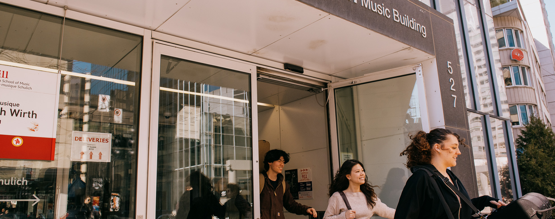 Young adults existing the Elizabeth Wirth music building