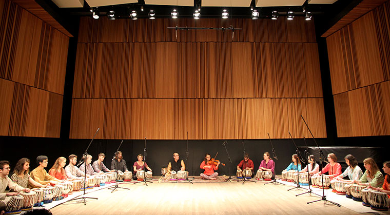 Tabla ensemble sitting on floor during rehearsal