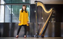 Melissa Achten with her instrument (harp)