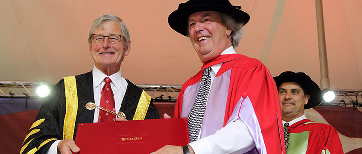 Chancellor Michael Meighen hands Robert Godin his Honorary Doctorate