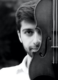 Artur Chakhmakhchyan holding a violin