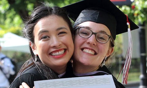 Alumni smiling on graduation day