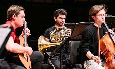 Three musicians playing instruments