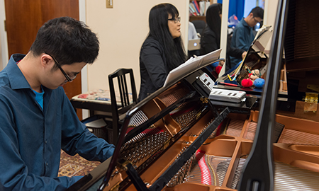 Piano professor with student at piano