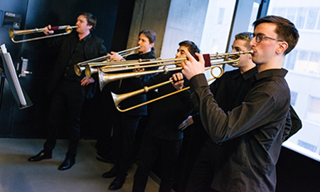 brass musicians standing in a line