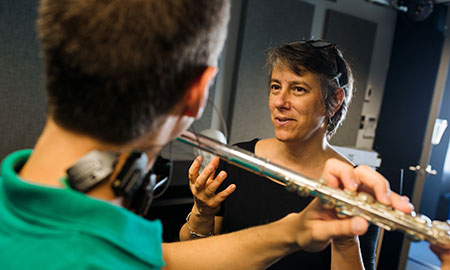 Professor show proper technique to flute student