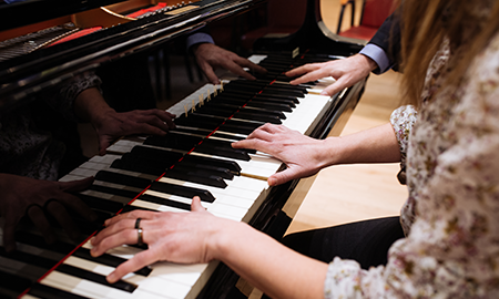 hands of student playing piano