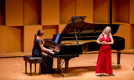 girl in red dress and pianist