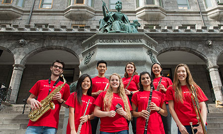 Students holdin ginstruments outside of the Stratchona Music building