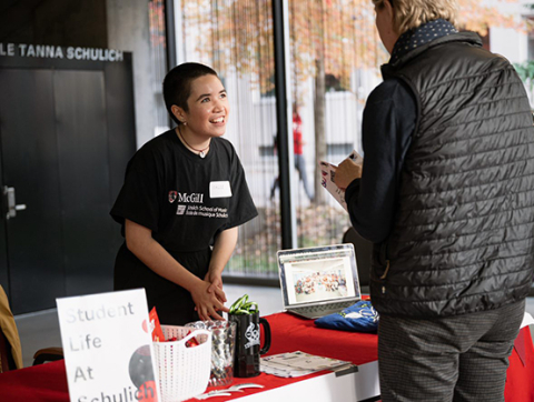 Schulich student welcomes applicant at registration table