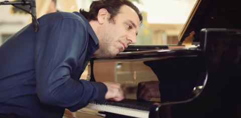 A close-up shot of pianist Chilly Gonzales performing.