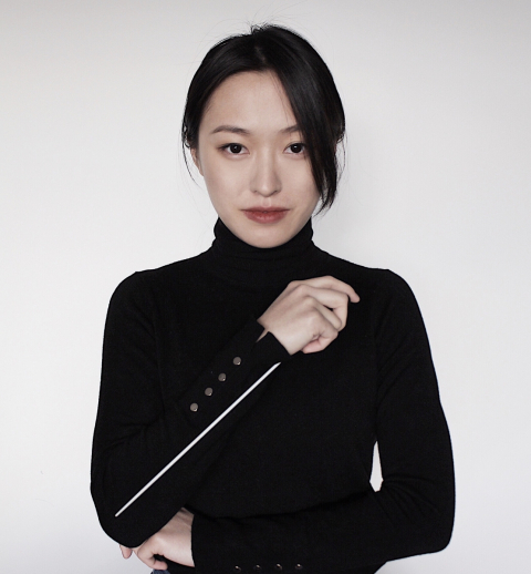 Kelly Lin holding a conducting baton