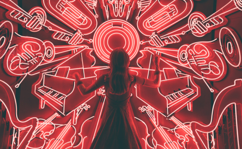 female figure in front of neon outlines of various instruments