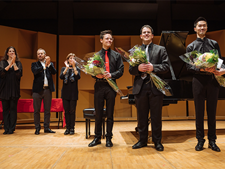 Awards recipients on stage holding flowers