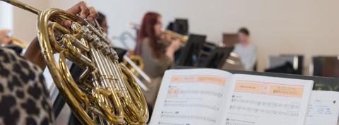 close up of student playing french horn